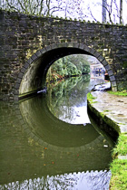 [ photo: Arched Bridge and Canal Boats Reflected in Hebden Canal, Hebden Bridge, Calder Valley, W Yorkshire, UK, Jan 2007 (img 119-005) ]